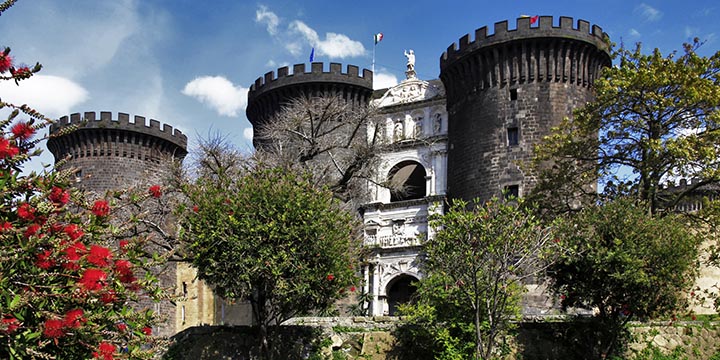 A scenic view of the New Castle (Castel Nuovo) in Naples, Italy on a sunny day