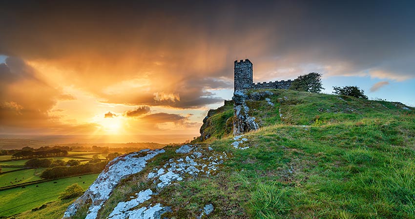 Sunset over a hilltop church in Dartmoor National Park, England.