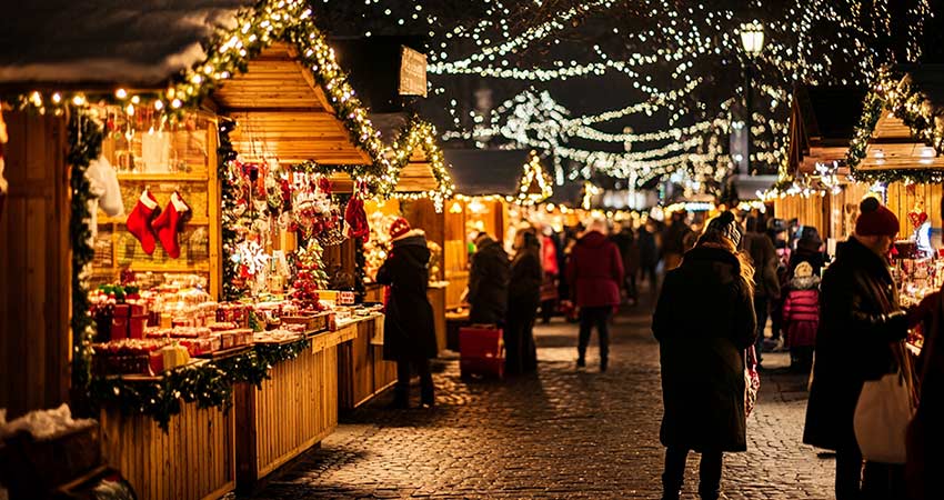Lincoln Christmas market at night with festive lights and holiday shoppers