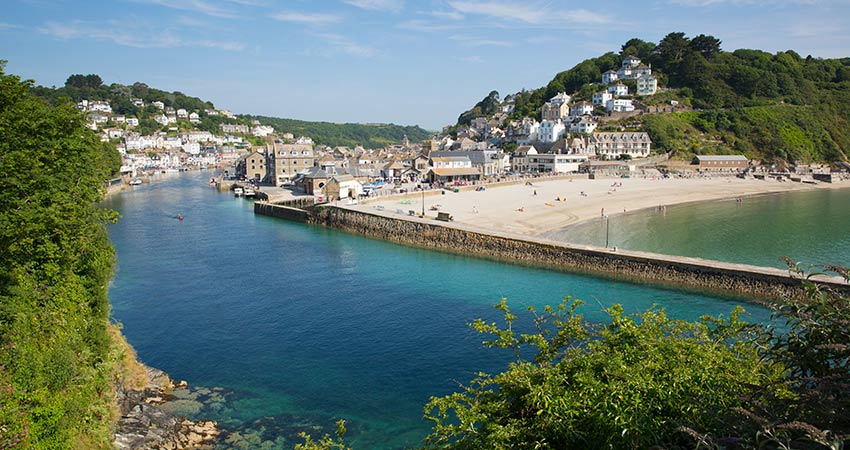 Coastal village of Polperro with harbor and sandy beach in Cornwall, England