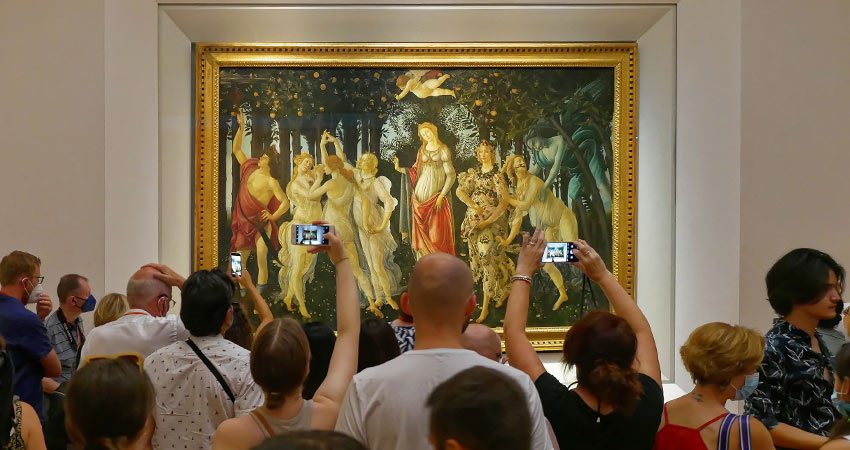 Visitors photographing Botticelli’s Primavera at the Uffizi Gallery in Florence, Italy
