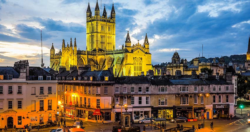 Bath Abbey illuminated at dusk in the city of Bath, England