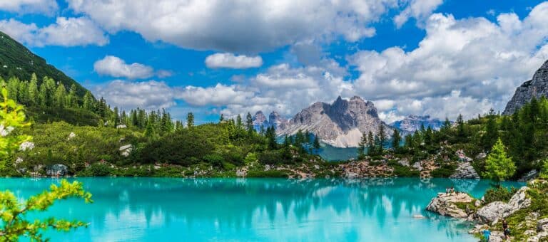 Gorgeous turquoise lake Sorapis in Italy with Dolomite mountain range in the background