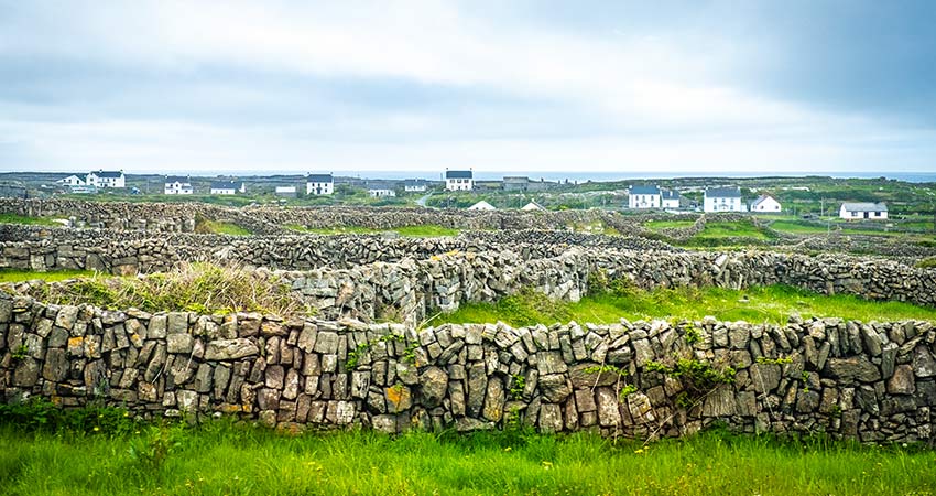 Aran island stone fort walls with homes in the background