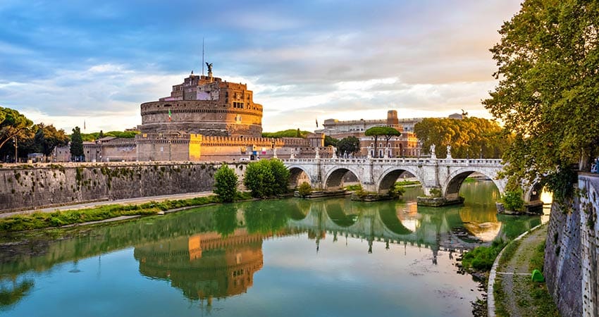 View of Castel Sant'Angelo with bridge and river in front during daylight