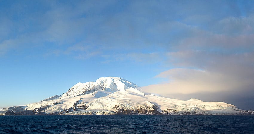 Snow covered Heard and McDonald Islands seen from a distance