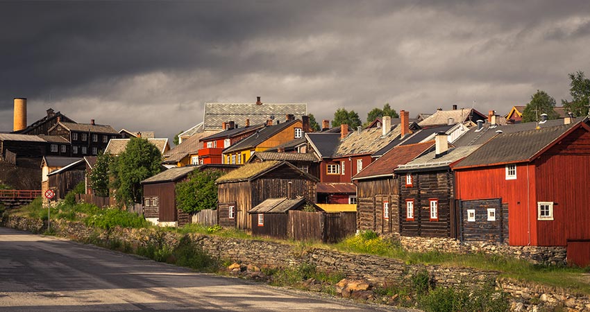 Old street architecture of mining town Roros in Norway showing wooden, colorful buildings