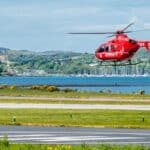 Scottish rescue helicopter taking flight in tourist vacation area