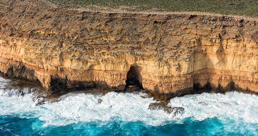 Aerial view of shark bay Australia with limestone cliffs and rough waters