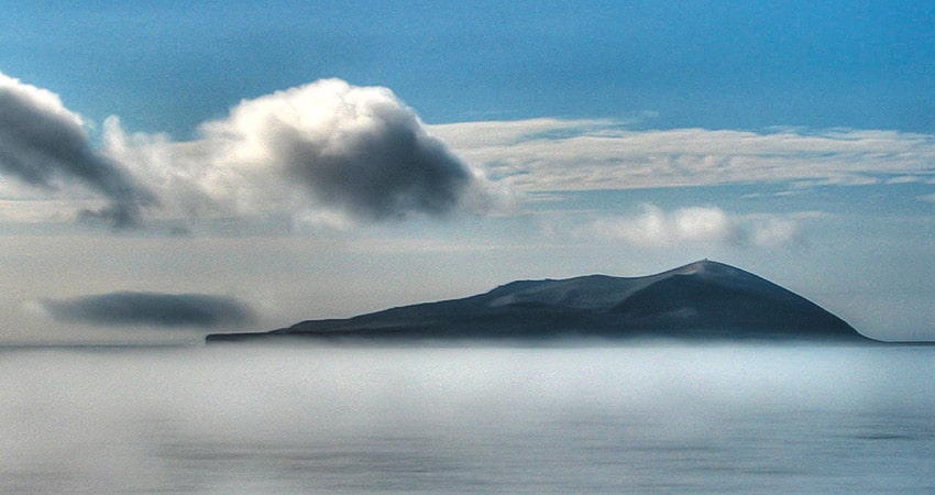 Surtsey island at a distance on a misty day