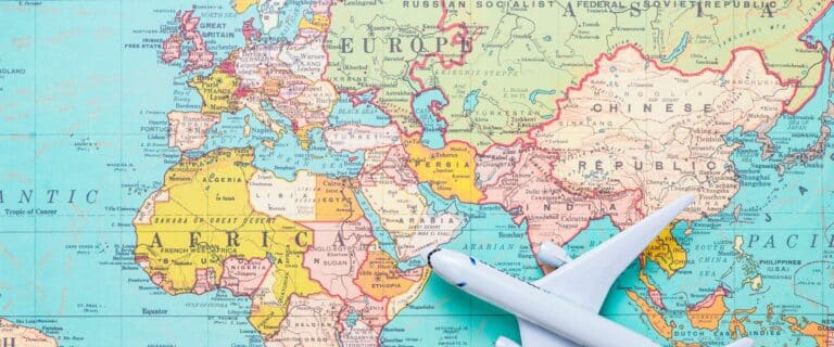 Image of toy airplane laying over world map