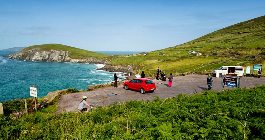 Tourists pulling over on Slea Head near Dingle to take in the views of the sea 